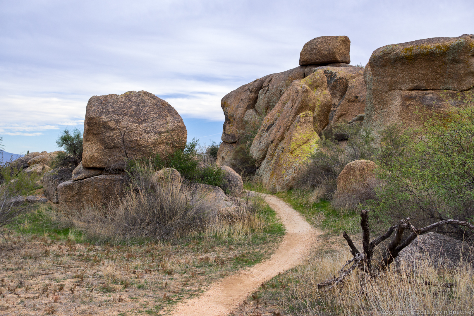 a trail going between two granite boulders